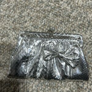 Rafe clutch leather snake detail with bow. Perfect for night out.